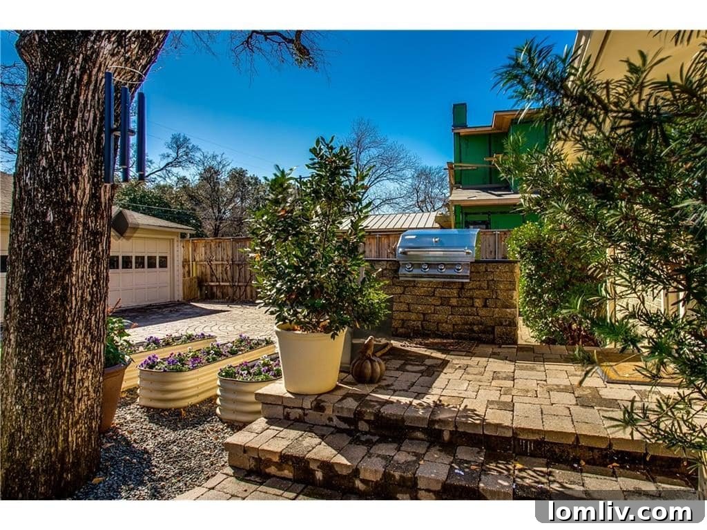 Spacious backyard patio with a built-in grill, perfect for outdoor entertaining in Dallas
