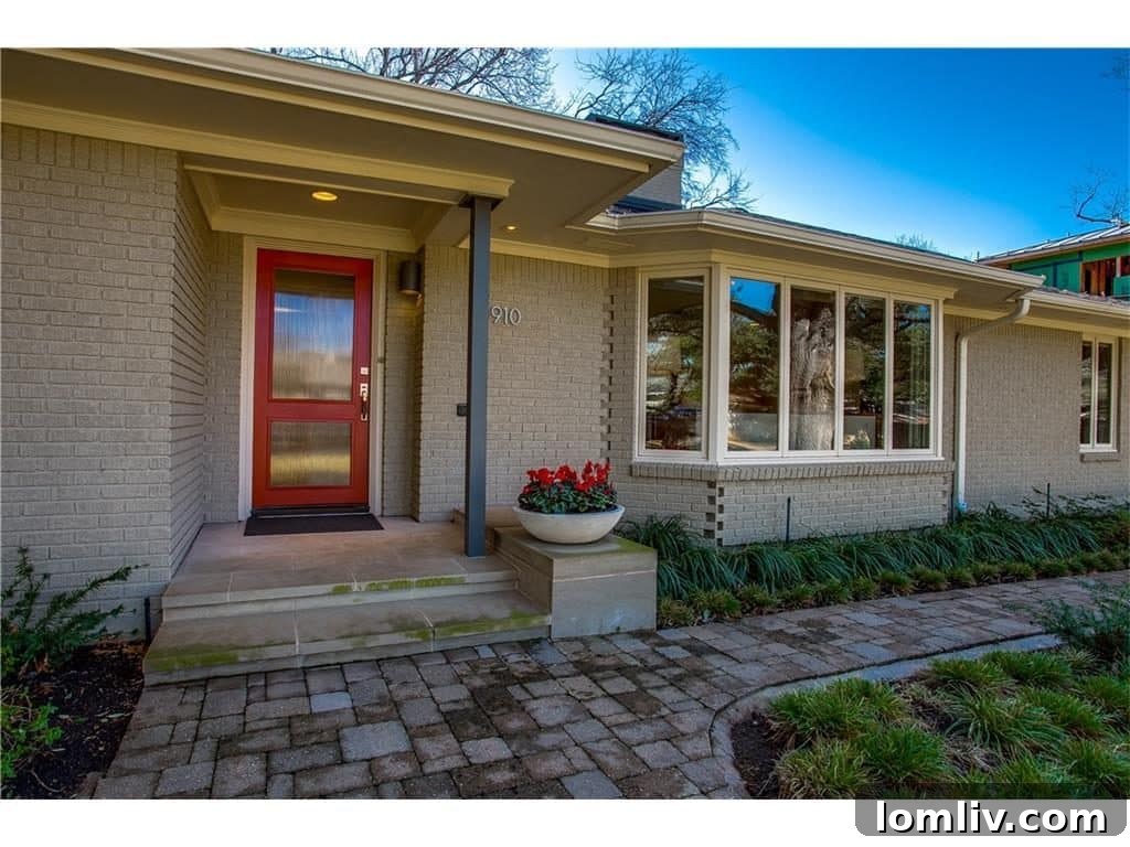 Bright and airy living room with large windows overlooking the mature trees in Mockingbird Park