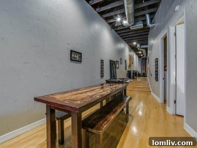 Master bedroom with exposed brick wall and stained concrete floors