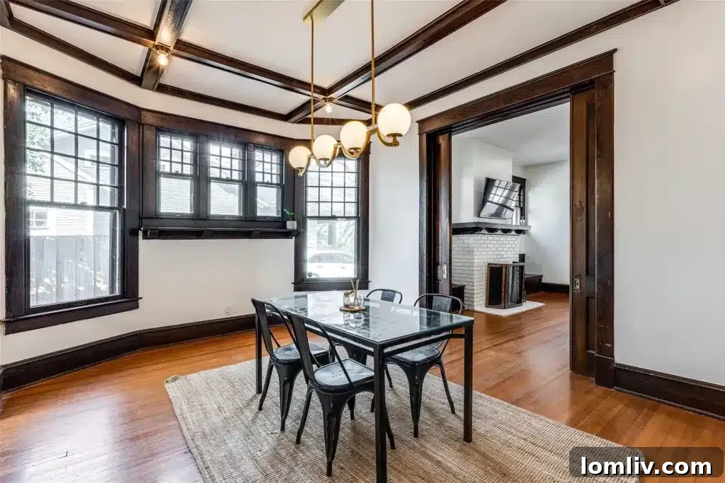 An elegant dining room in a historic Winnetka Heights home, showcasing coffered ceilings with original millwork and classic furnishings.