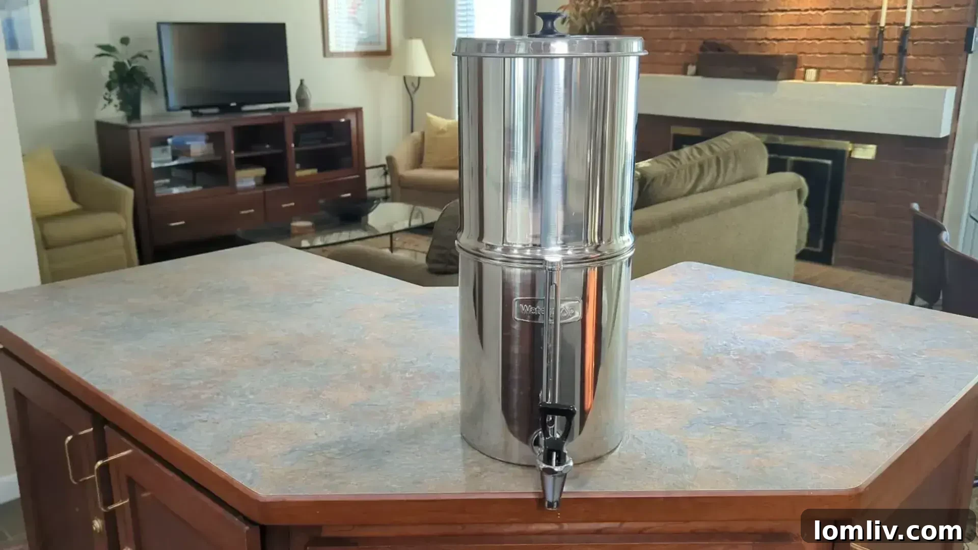 Person pouring filtered water from a benchtop water filter into a glass, highlighting clean drinking water.