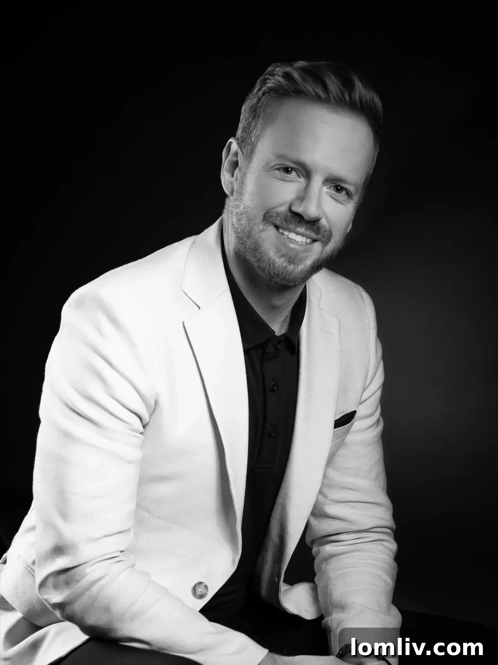 Brad Saunders, founder of Elevation Real Estate Group, standing in front of a modern building in Calgary.