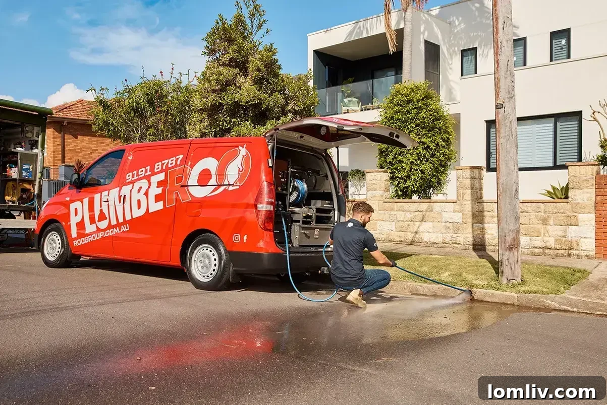 A professional plumber conducting hydrojetting on a sewer pipe.
