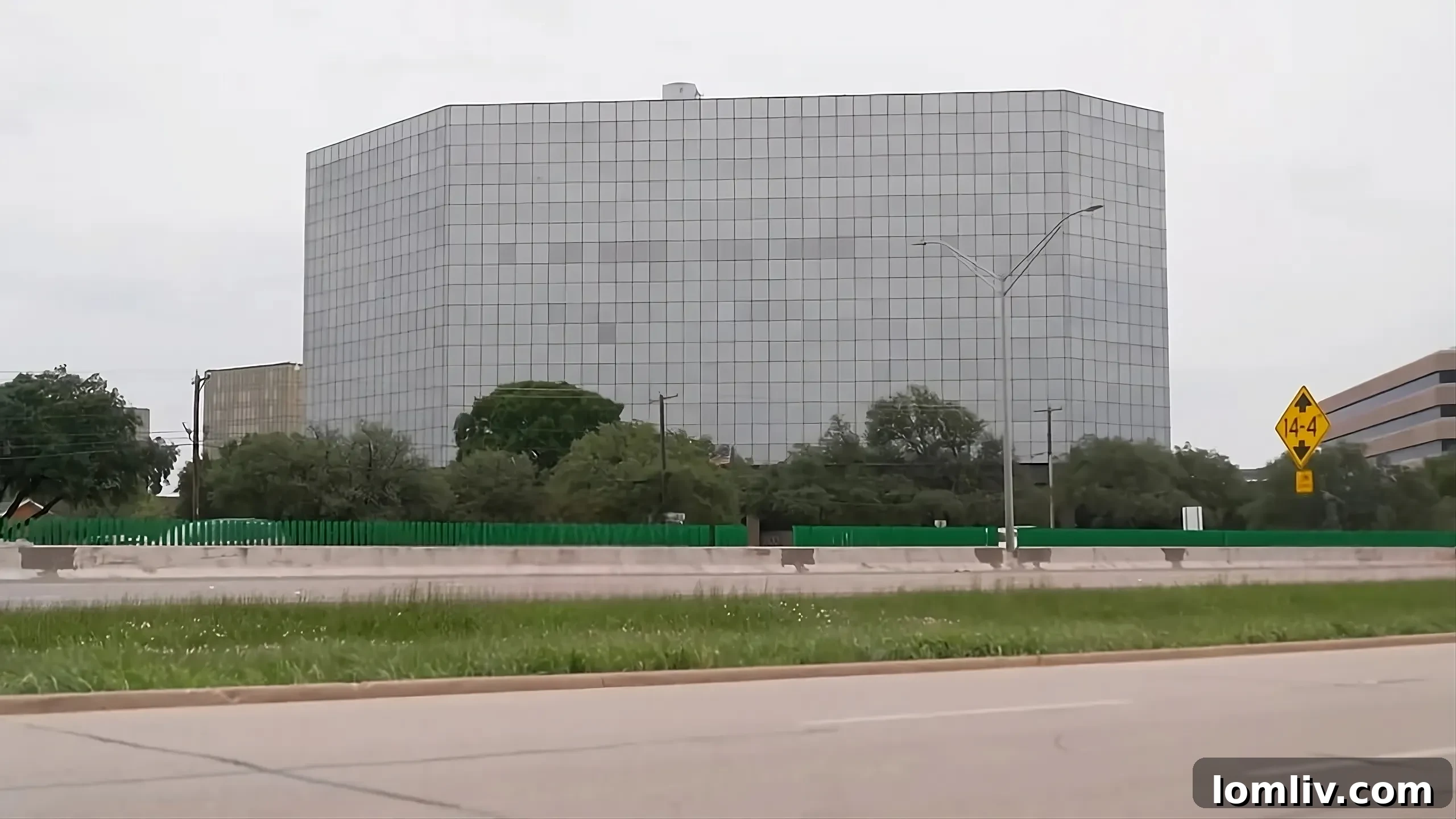 Dallas City Hall building in the foreground with the city skyline in the background, symbolizing urban governance and development challenges.
