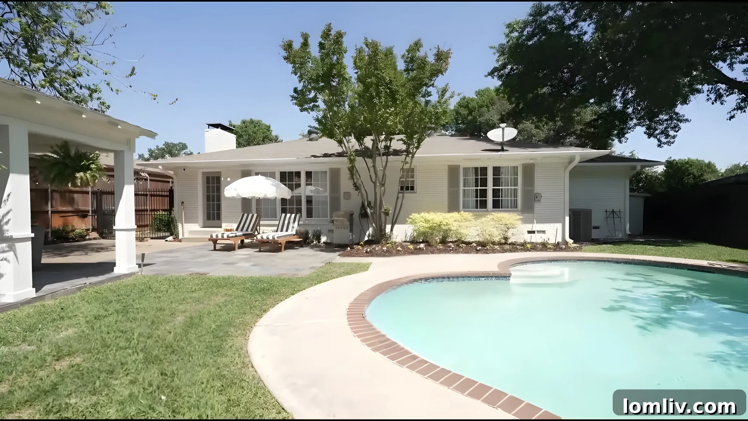 Lexie Witt Townsend's beautiful backyard featuring a swimming pool, string lights, and a spacious patio area.