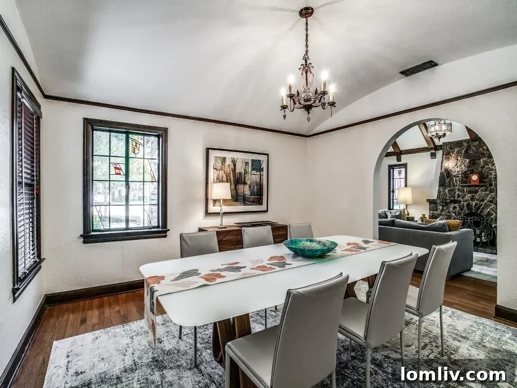 M Streets Tudor: Crafted with Care, Lived with Love 6 Spacious formal living room with vaulted cathedral ceiling and stone fireplace