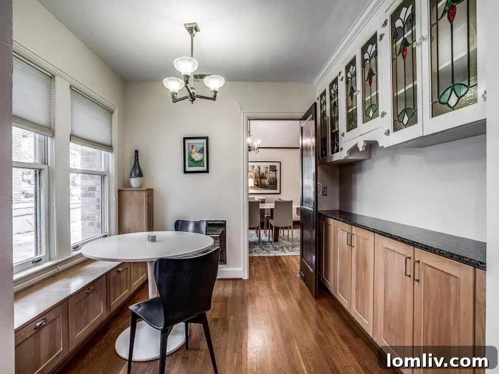 M Streets Tudor: Crafted with Care, Lived with Love 7 Modern chef's kitchen with granite countertops, stainless steel appliances, and shaker cabinetry