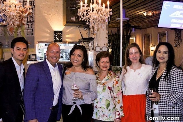 Diverse group of real estate agents celebrating the launch of EHC Latino, a new initiative to serve the Hispanic community.