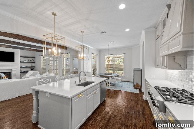Open concept living area with hardwood floors and large kitchen island in Westcliff home