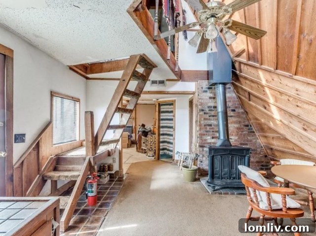 Detailed view of the Oklahoma A-frame's rustic shiplap woodwork and interior ladder.