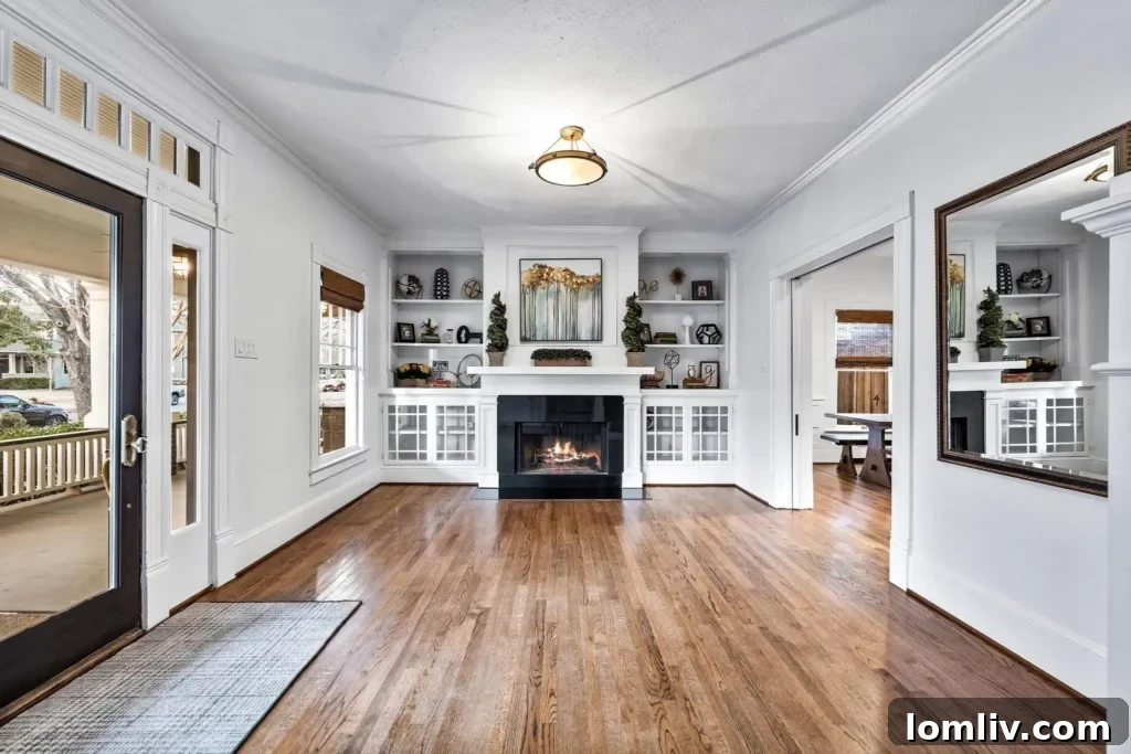 Elegant formal living room with fireplace and built-ins in historic Dallas home