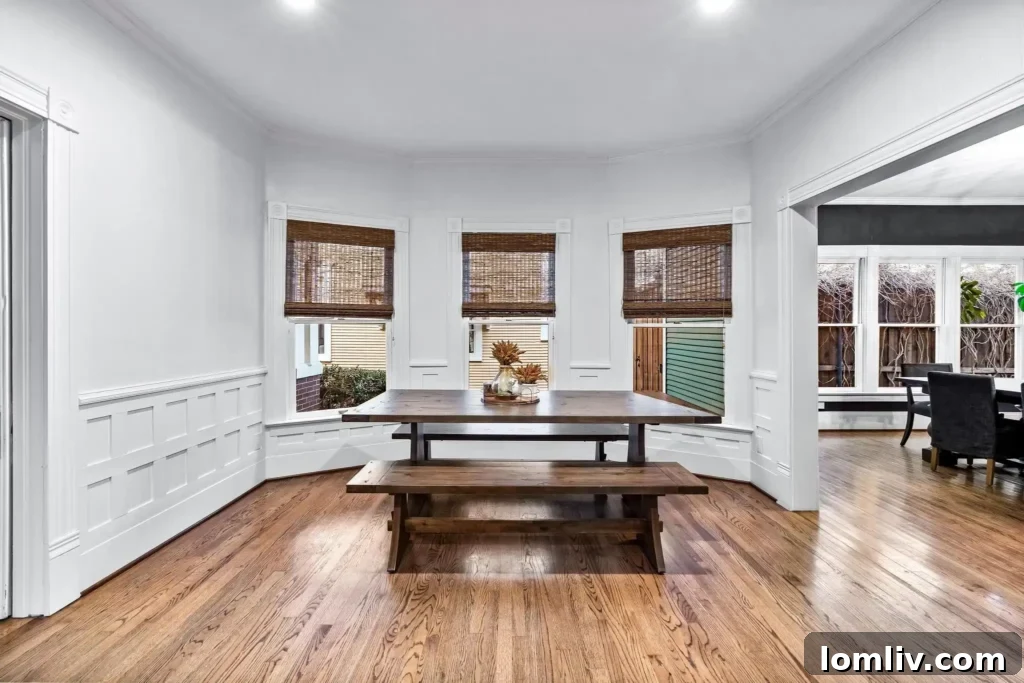 Spacious formal dining area with large windows and modern chandelier