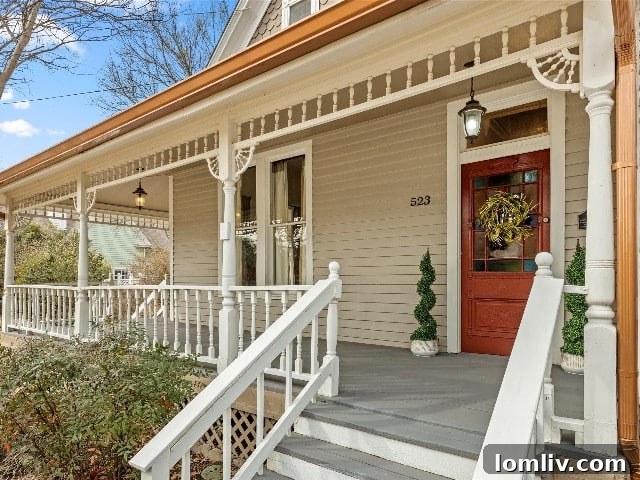 Waxahachie Queen Anne Victorian: A True Gingerbread Fairytale 4 A close-up view of a Queen Anne Victorian home, highlighting its inviting deep front porch, decorative spindles, intricate woodwork, and charming transom windows, characteristic of the style.