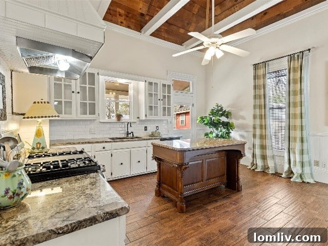 Waxahachie Queen Anne Victorian: A True Gingerbread Fairytale 7 The thoughtfully updated kitchen maintains a classic style that beautifully complements the historic character of the Queen Anne Victorian home, offering modern functionality.