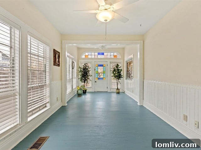 Waxahachie Queen Anne Victorian: A True Gingerbread Fairytale 9 The inviting, fully enclosed sun porch of the Waxahachie Queen Anne Victorian home, an ideal spot for morning coffee and evening relaxation.