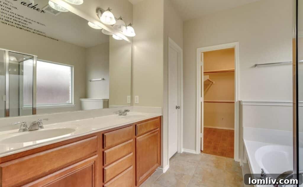 Comfortable master bedroom with ceiling fan and plush carpeting