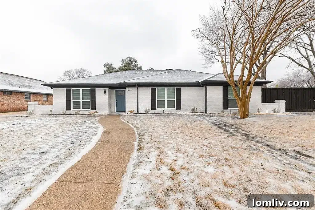 A stunning renovated home in Plano with a beautifully landscaped front yard and inviting entrance.