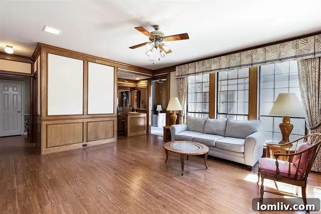 A spacious living room inside the Plano home, featuring a fireplace and ample natural light.