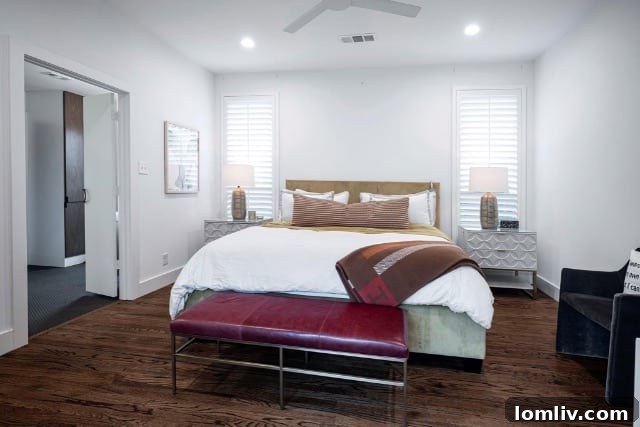 Primary bedroom with red leather bench and green bed