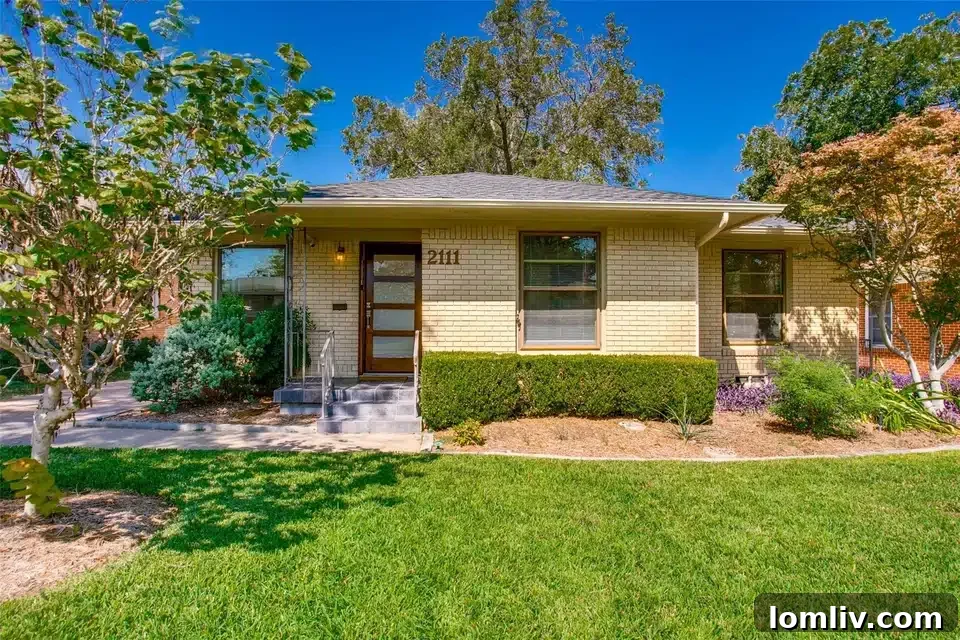 An charming updated starter home in Oak Cliff, Dallas, featuring a welcoming facade with a mix of brick and siding, a neat front yard, and a classic design that blends vintage appeal with modern updates.