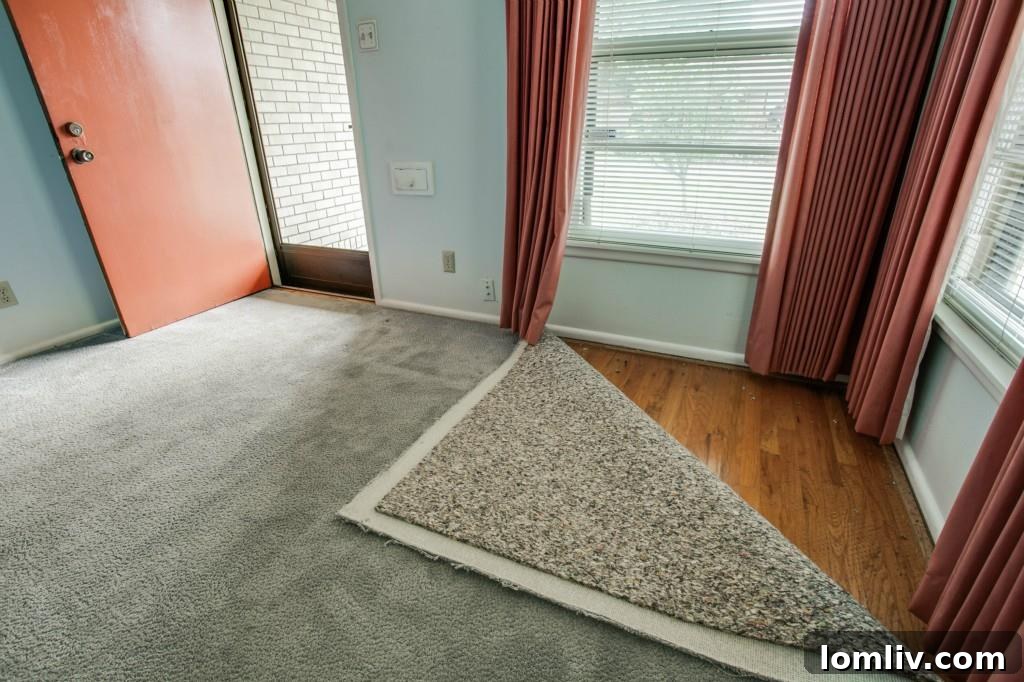 A 'before' image of the living room showcasing the original, darker hardwood floors and classic decor from a previous MLS listing, highlighting the significant transformation achieved by the current owner.