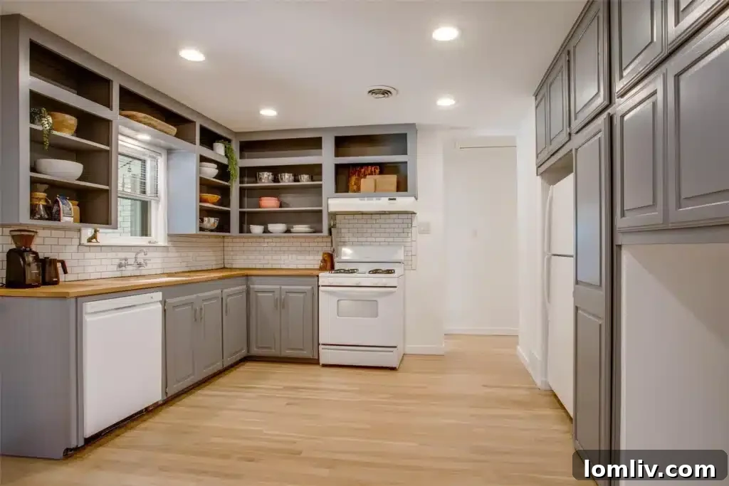 A closer look at the kitchen's stylish details, featuring warm wood tones from the butcher block, the clean lines of the subway tile, and practical lower cabinetry contrasted with decorative open shelves.