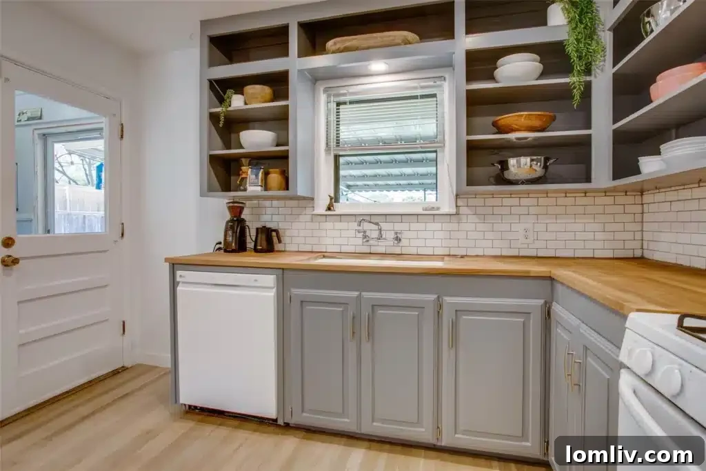 A bright and inviting bedroom in the Oak Cliff home, featuring beautifully restored hardwood floors, neutral walls, and ample natural light, creating a serene and comfortable retreat.