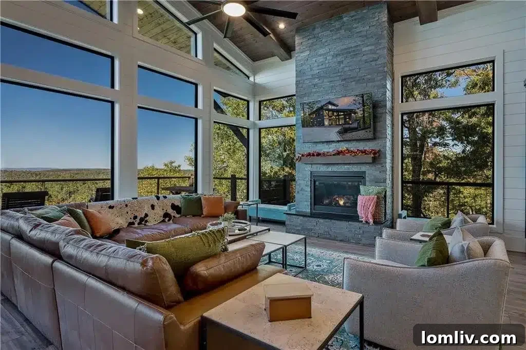 Interior view of the great room in 'Above and Beyond' with a stone fireplace and mountain views