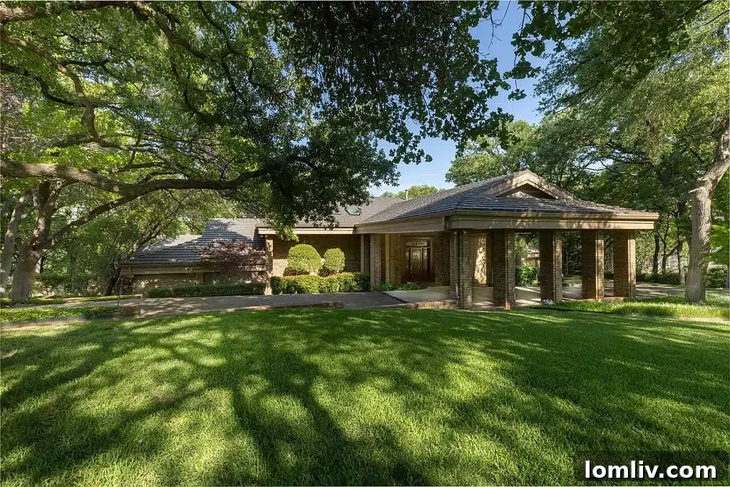Gated entrance to a private, wooded luxury estate near AT&T Stadium
