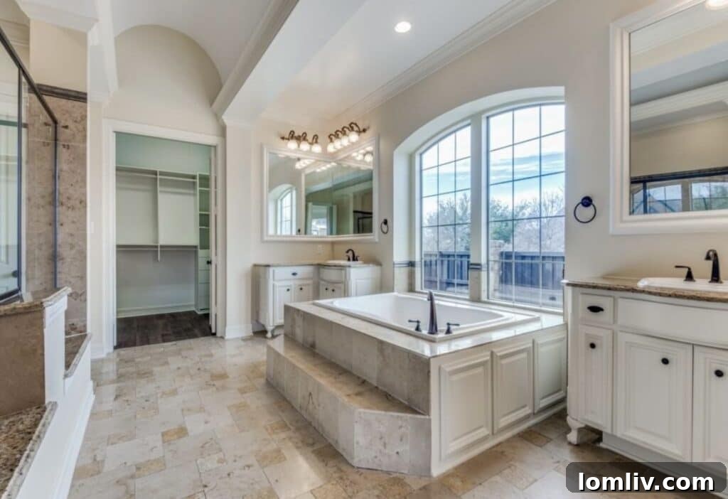 Luxurious master bathroom with dual vanities and soaking tub
