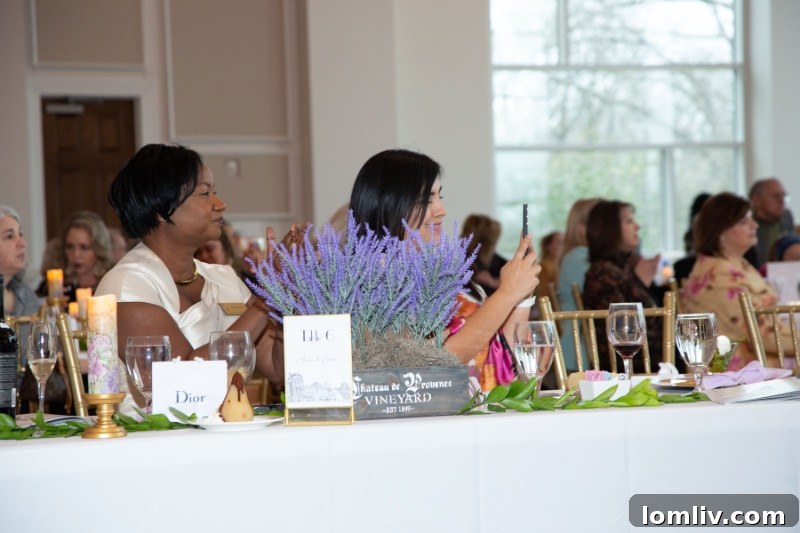 Attendees mingling during the silent auction at the French-themed Garden of Roses Fundraiser.
