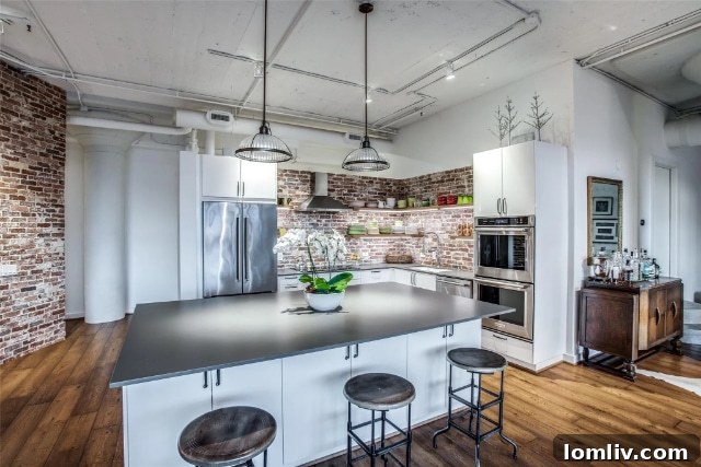 Interior view of a loft featuring exposed brick walls and high ceilings