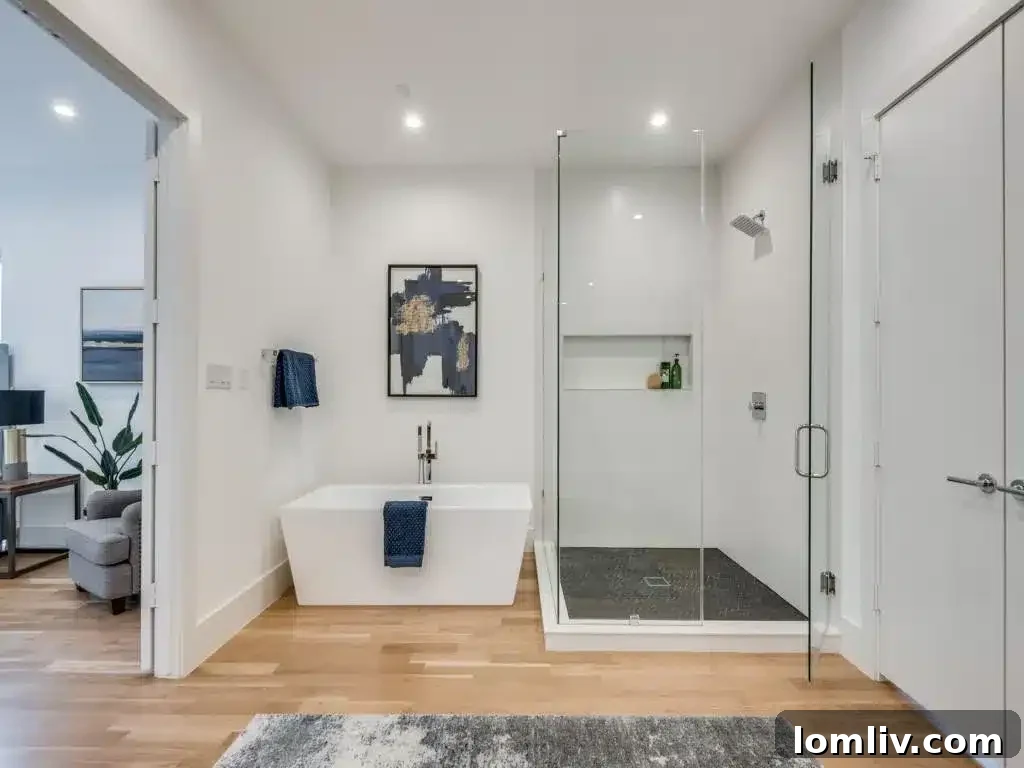 Spa-like primary bathroom featuring a freestanding tub and ample natural light