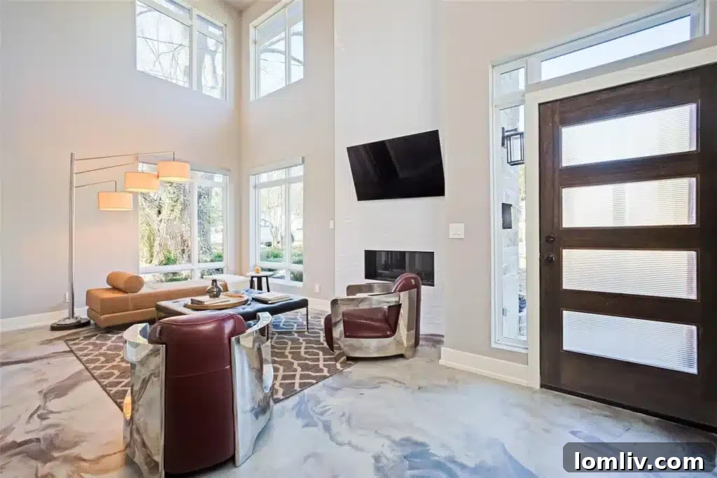 Two-story entry flooded with natural light from ample windows