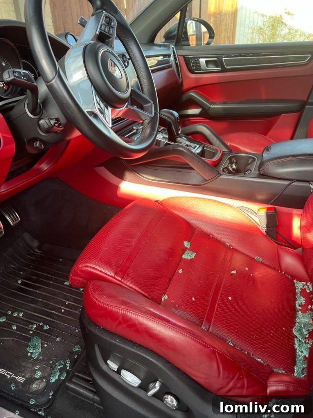 Close-up view of damage to Rita Goodsell’s car window, indicating a break-in.