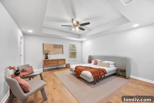 Spacious primary bedroom with abundant natural light