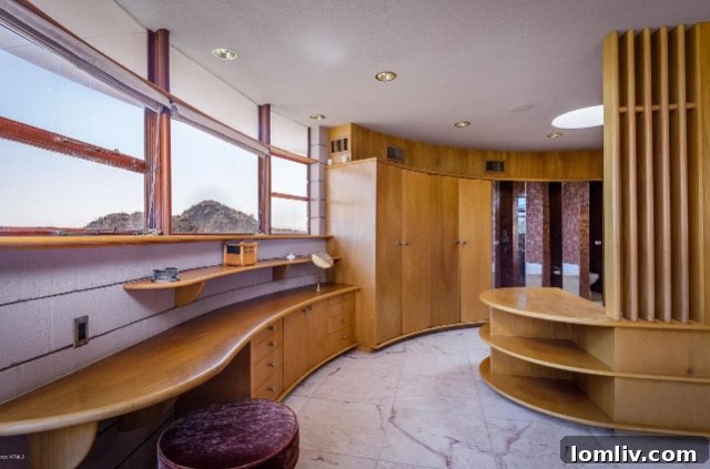 Another bedroom view highlighting the warmth of Philippine mahogany and abundant natural light, characteristic of Frank Lloyd Wright's design