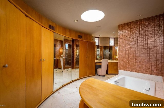Another view of a luxurious bathroom, showcasing timeless fixtures and the home's distinctive design continuity