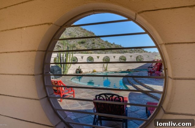 Outdoor seating area with a view of the desert landscape and the curved architectural beauty of the Circular Sun House