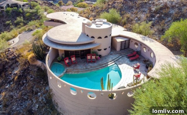 Circular living room interior of Frank Lloyd Wright's Circular Sun House, featuring built-in furniture and panoramic desert views