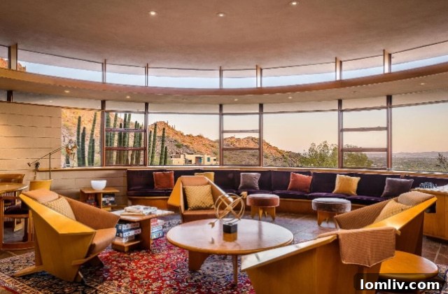 A striking purple velvet couch within the unique, curved interior of the Norman Lykes House, a blend of luxury and iconic design