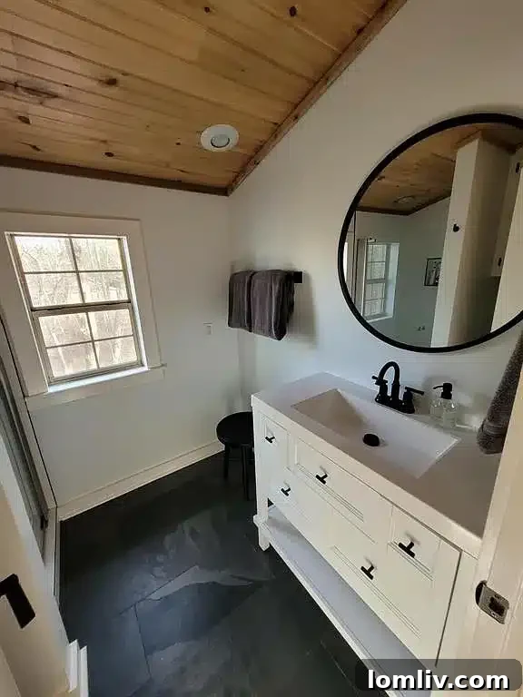 Elegant bathroom with sleek slate tile and modern fixtures in Winnsboro home