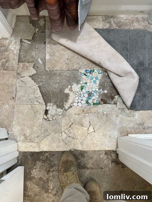 Smart Home Improvements: Avoid Regrets, Maximize Value 4 DIY floor tile repair fail: Mismatched mosaic with pebbles, showing a failed attempt to fix a broken floor