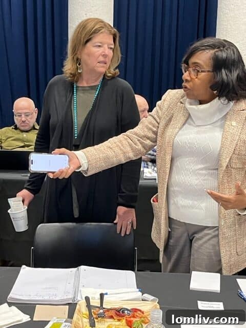 Councilwomen Jaynie Schultz and Carolyn King Arnold engage in discussions during the Dallas City Council vision session, reflecting on diverse district needs.