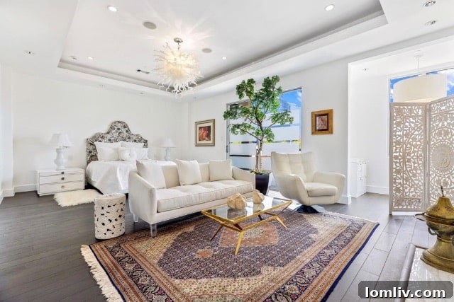Another view of the elegant living area, showcasing tasteful art and decor against white walls.