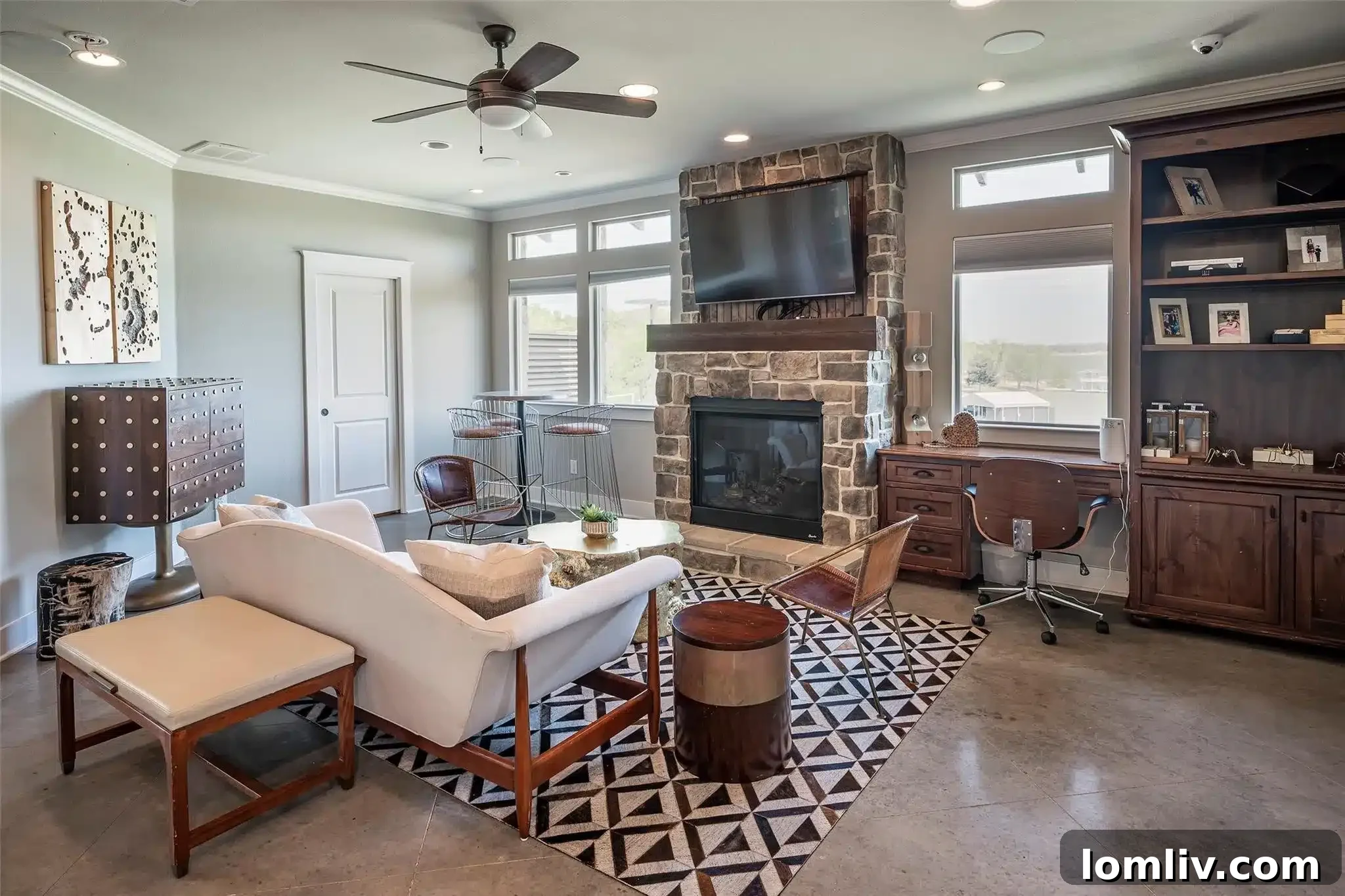 Open-concept living room within the detached guest house, featuring a cozy fireplace, comfortable seating, and a modern aesthetic.