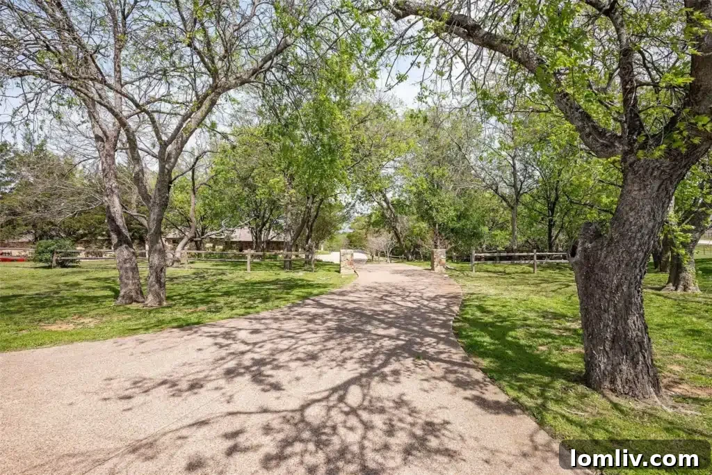 Gated entrance to 218 Hunter Pass, featuring a stone wall and lush greenery, hinting at the private luxury within.