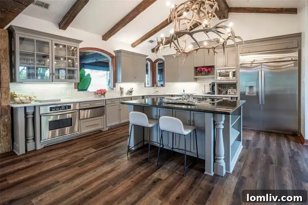 Elegant dining area with a contemporary light fixture, surrounded by natural stone walls and large windows offering views of the picturesque lake.