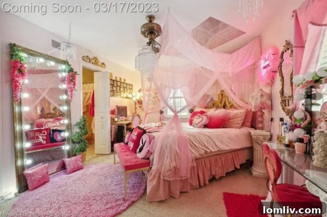 Close-up of the lighted mirror and pink decor in the bedroom, showing thoughtful detail