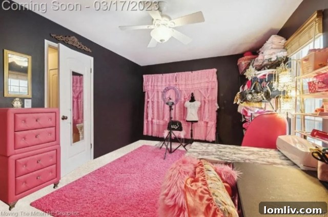 Another view of a pink-themed secondary bedroom with bold accents and art